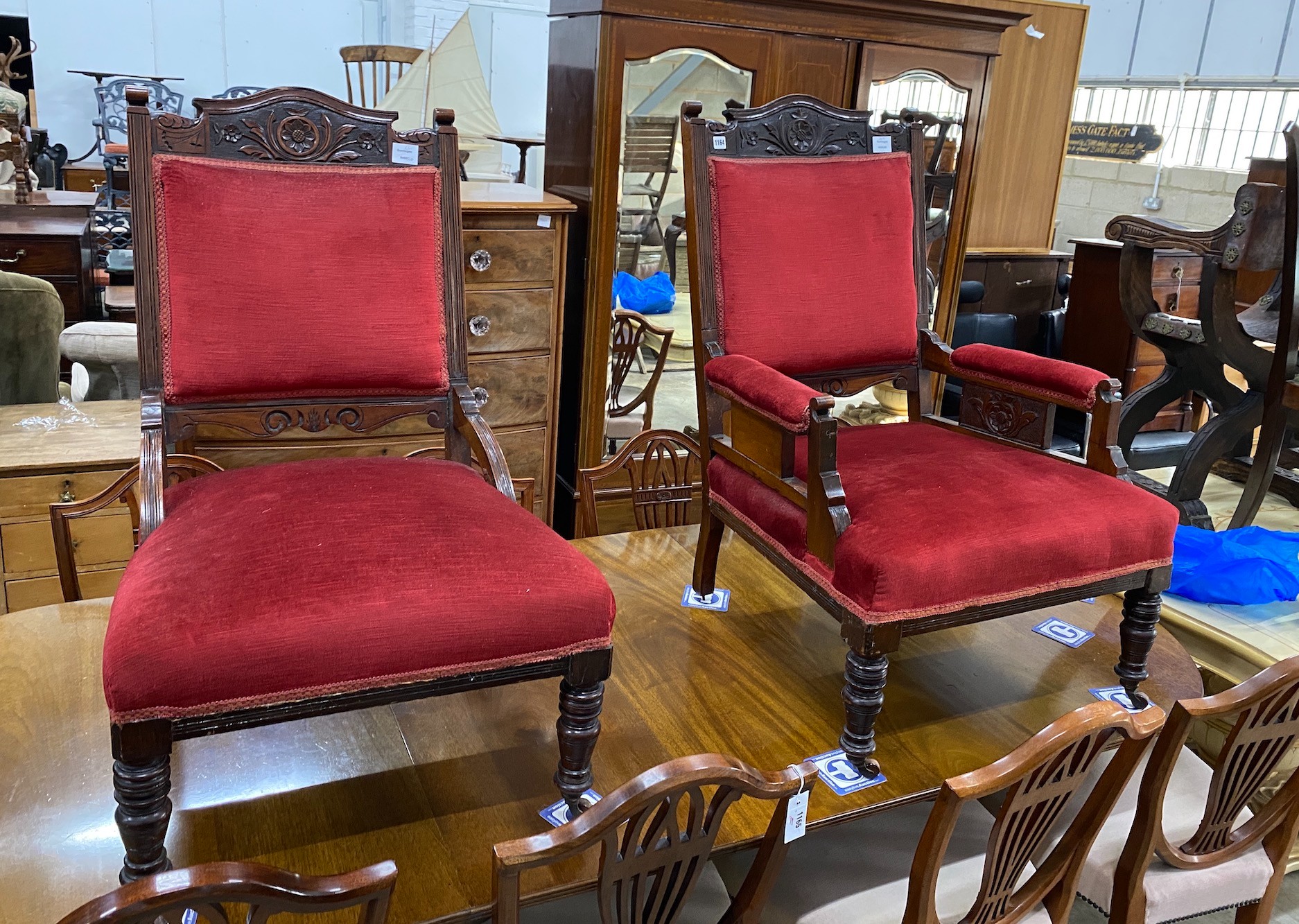 A pair of late Victorian carved mahogany upholstered salon chairs, one with arms, width 70cm, depth 61cm, height 100cm
